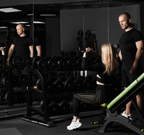 Trainer assisting client